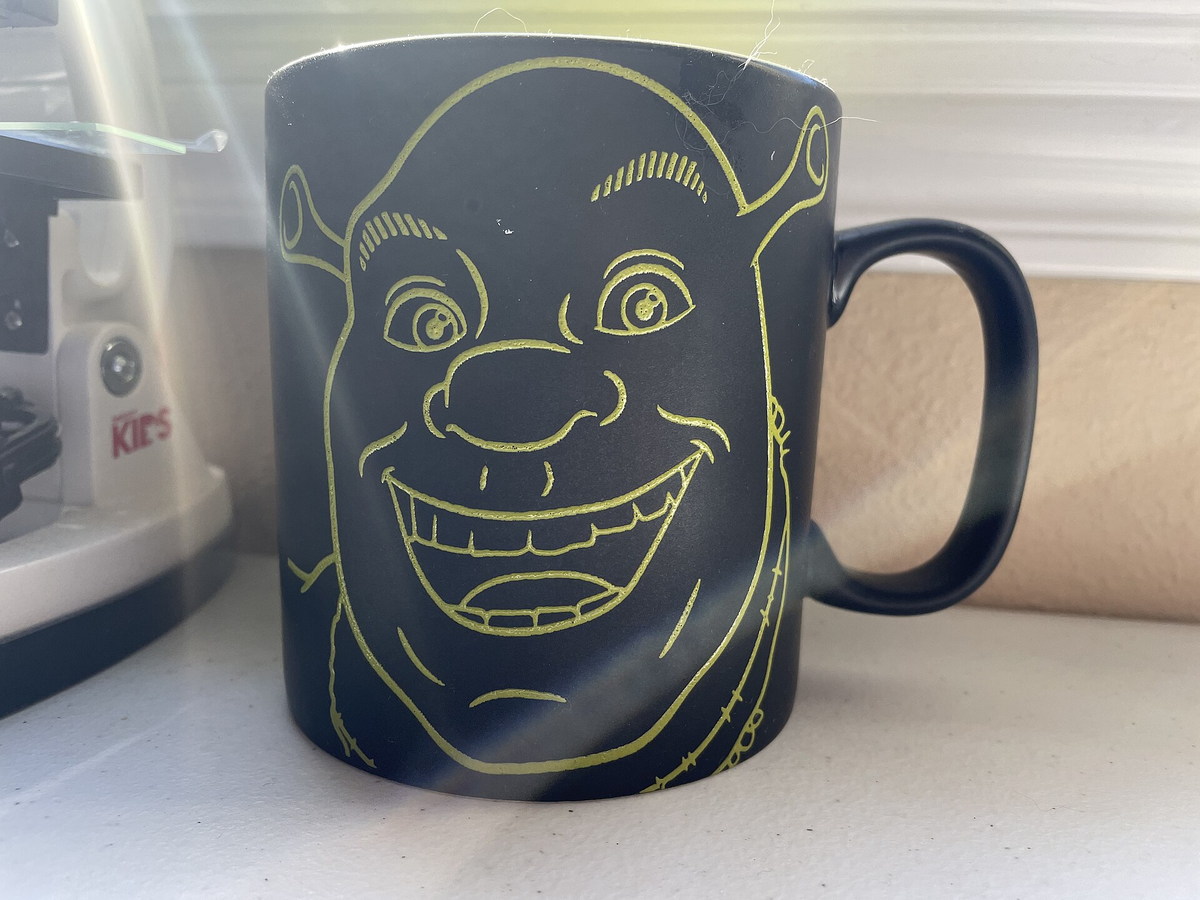 Green ceramic mug designed to look like Shrek
