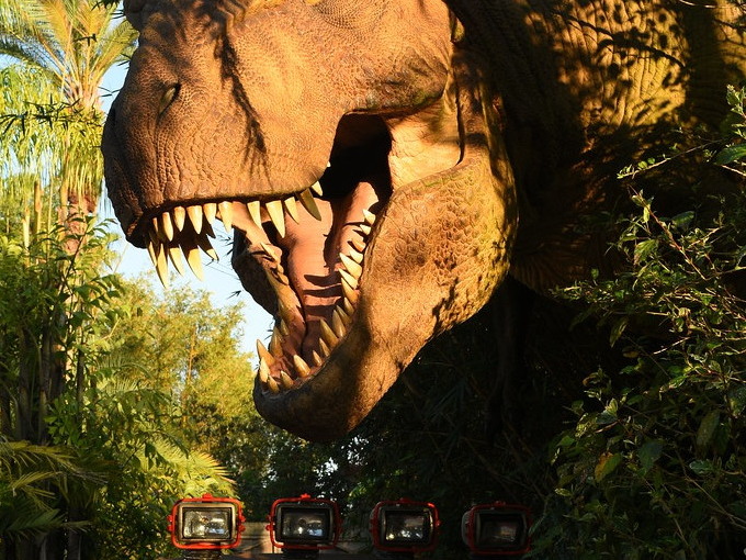 Jurassic Park Tyrannosaurus rex display looming over a Jeep