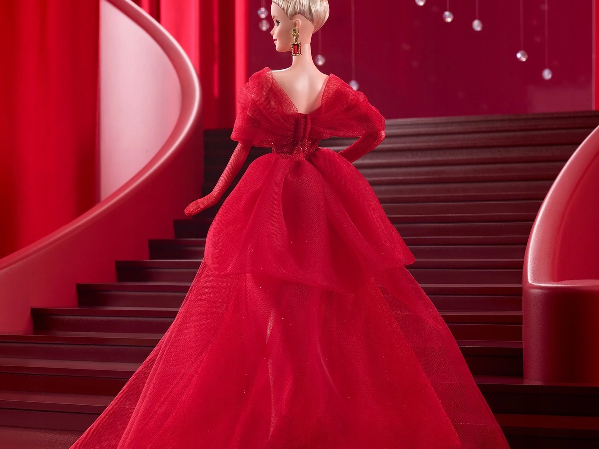 A Barbie Signature collector doll wearing a red gown