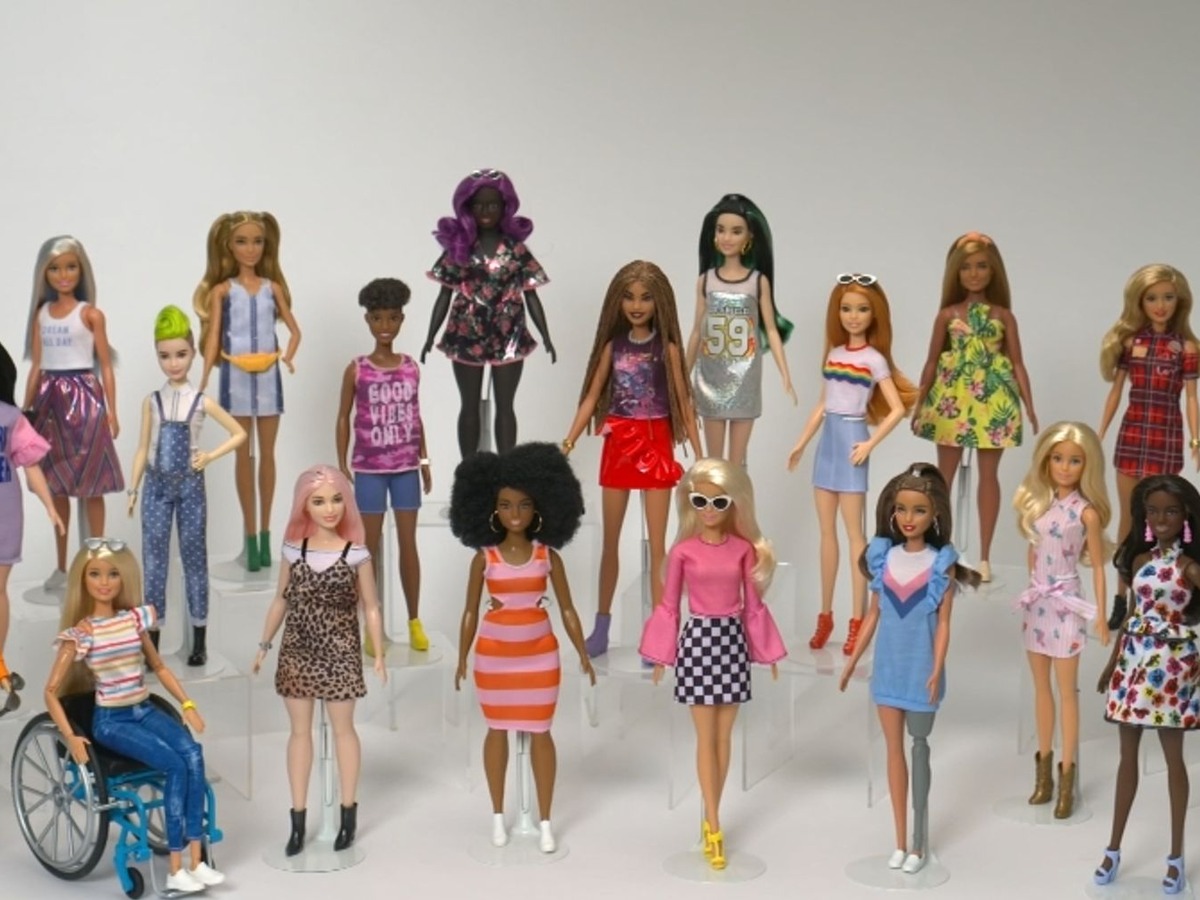 A diverse collection of Barbie dolls in modern outfits