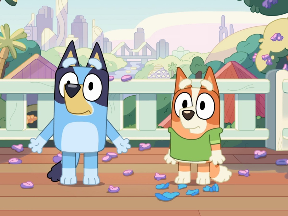 Bluey and Bingo standing together on the family deck