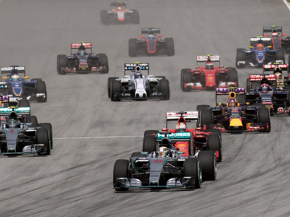 Formula 1 cars racing on the opening lap of the Malaysian Grand Prix