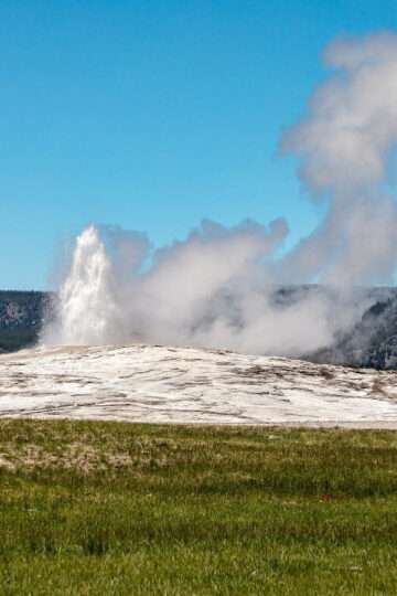 Old Faithful geyser erupting in Yellowstone National Park