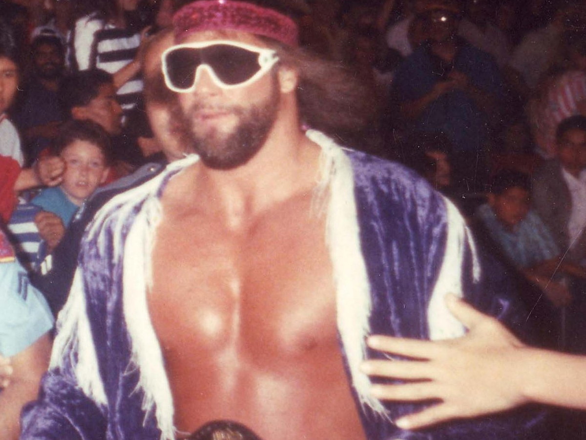 Randy Savage wearing the WWF Championship during a 1989 arena entrance