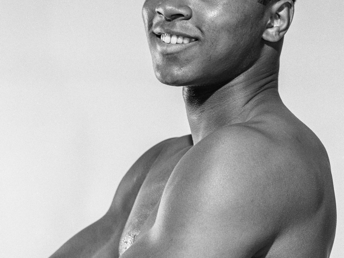Portrait of boxer Muhammad Ali smiling in 1962