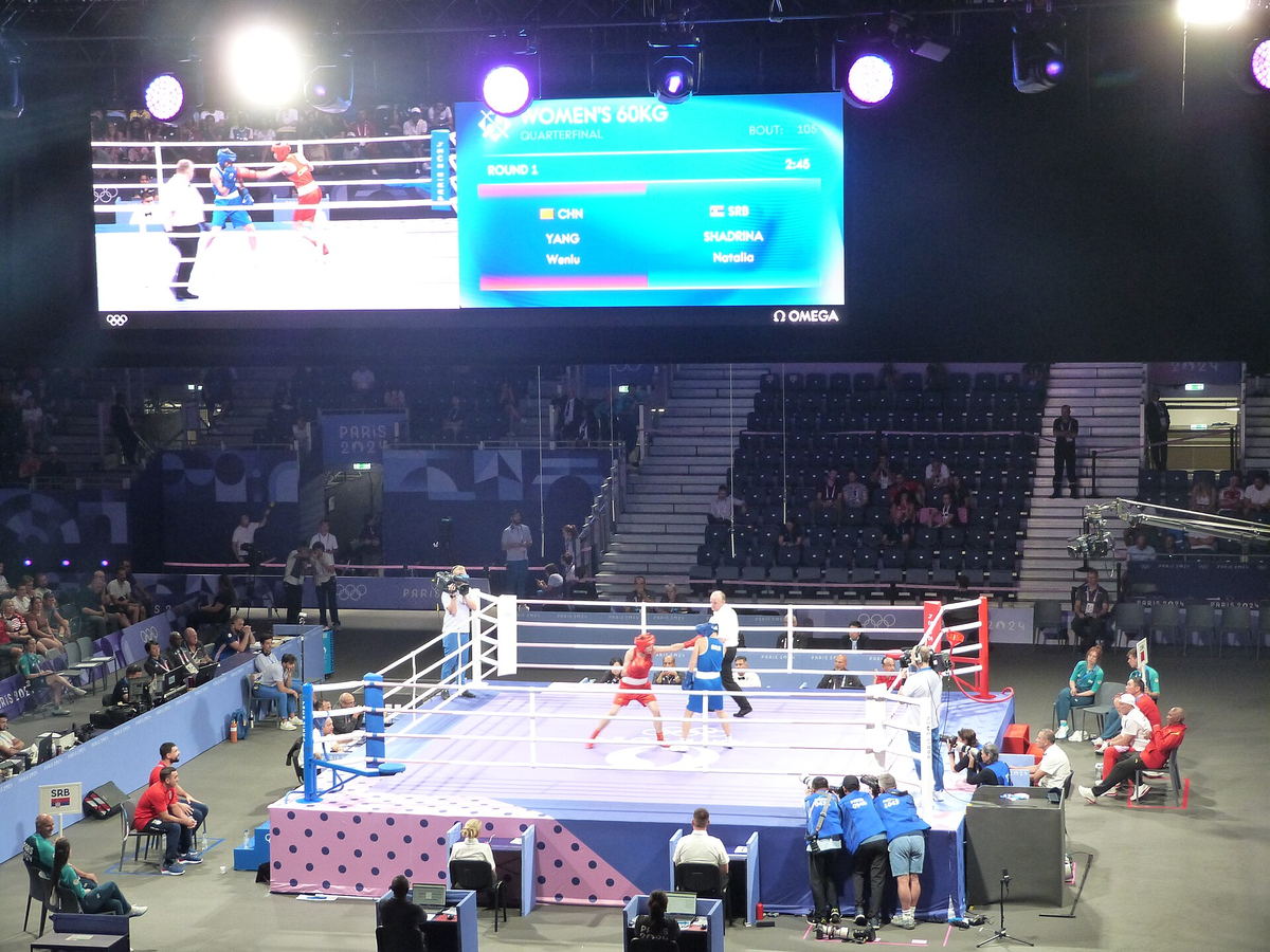 Yang Wenlu and Natalia Shadrina competing in an Olympic women's boxing match in 2024