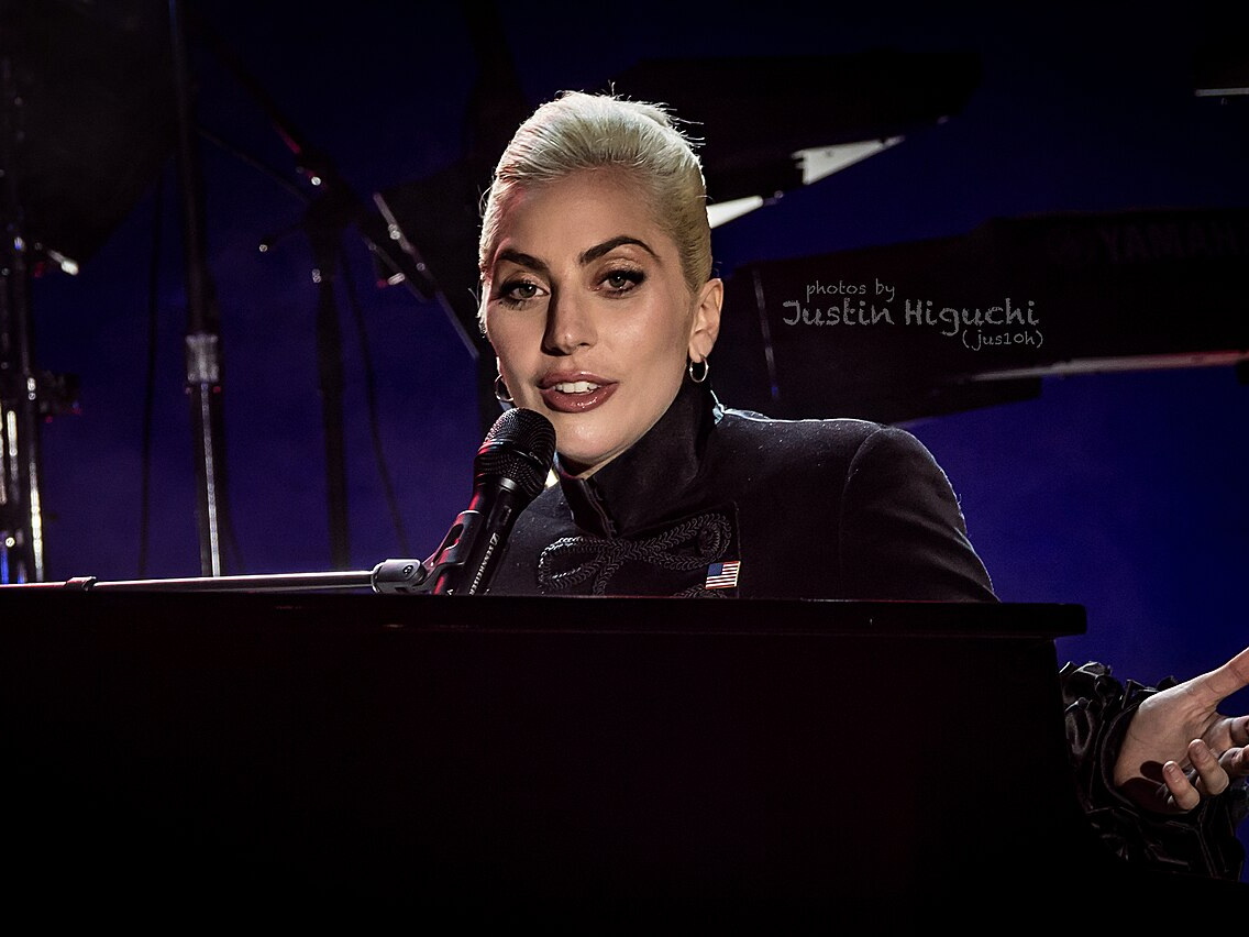 Lady Gaga performs under a spotlight at the 2016 Airbnb Open concert in Los Angeles