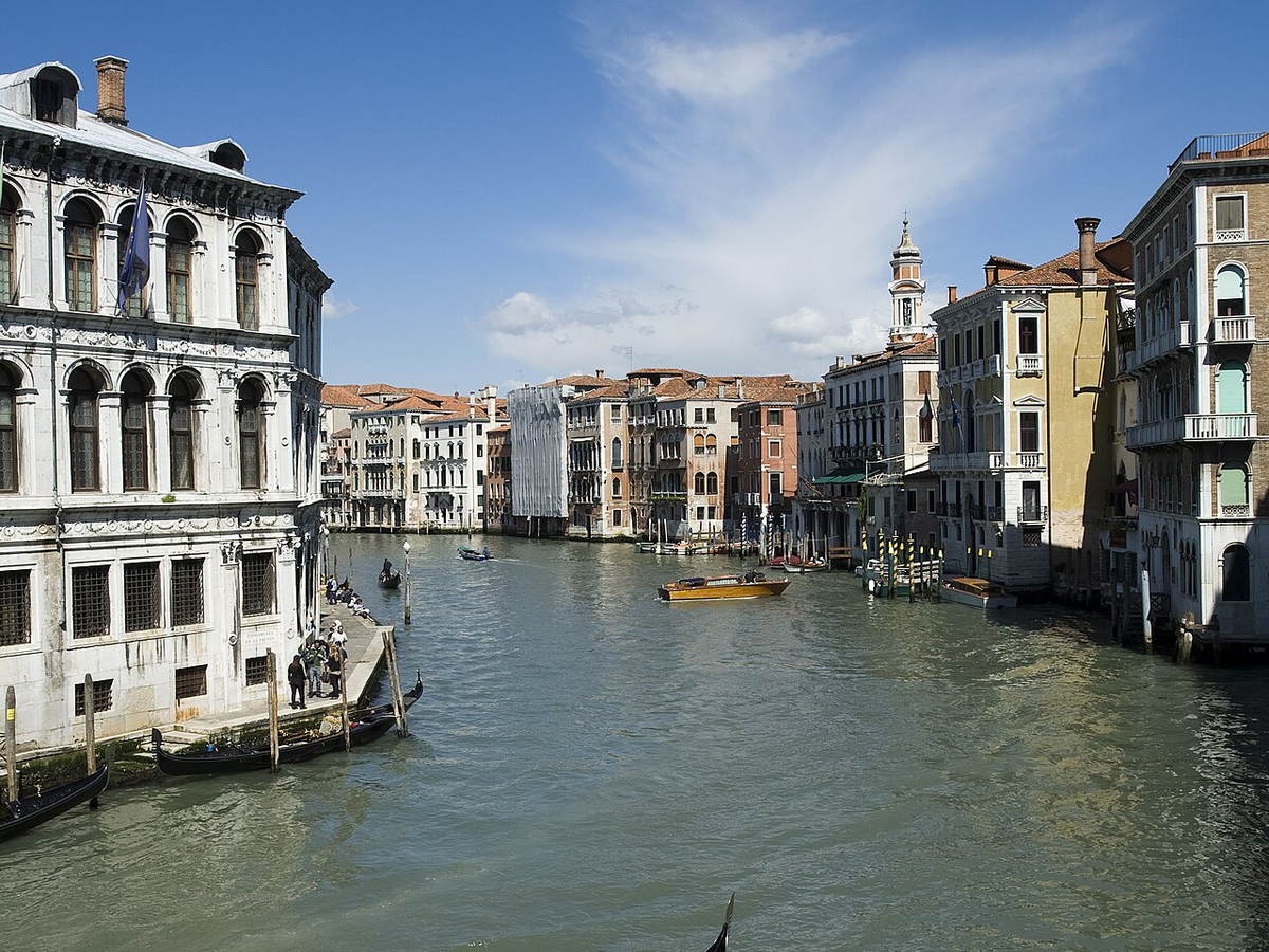 Gondolier traveling along the Grand Canal in Venice, Italy