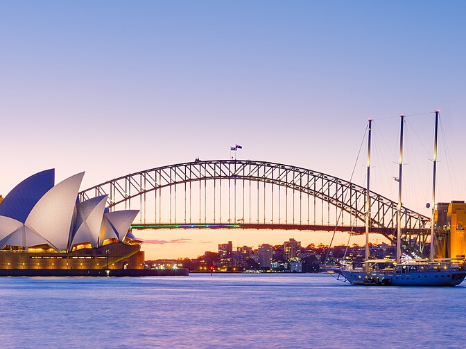 Sydney Opera House and Sydney Harbour Bridge illuminated at dusk