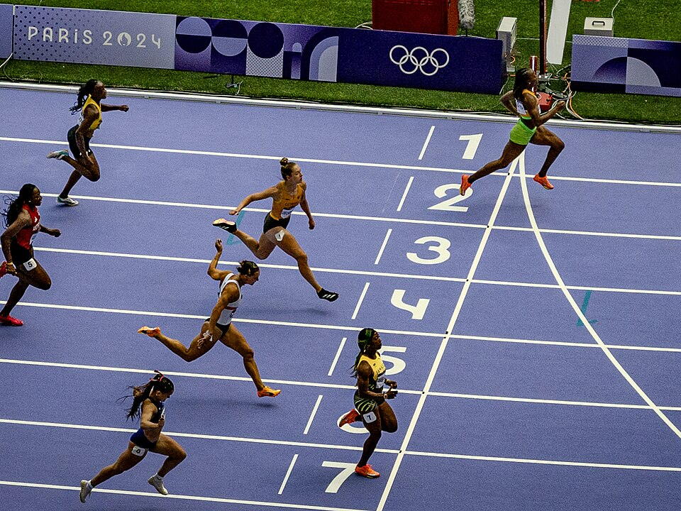 Athletes competing in a women's 100 metres heat at the Paris 2024 Olympics