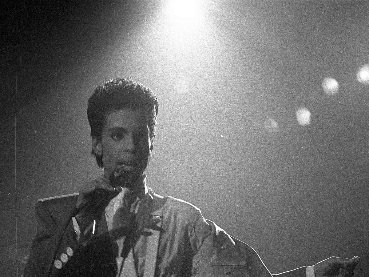 Prince performing onstage in Brussels in 1986