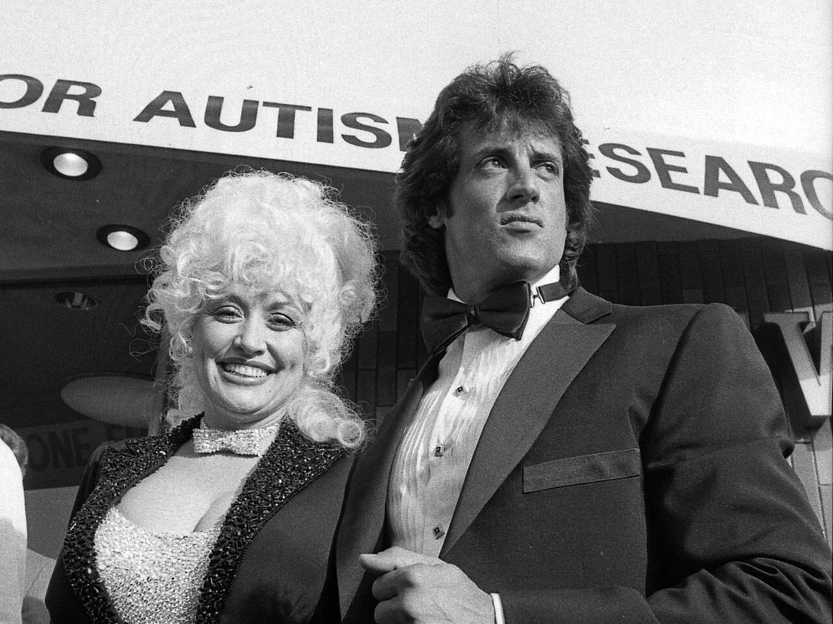 Dolly Parton and Sylvester Stallone arriving at a benefit screening of Rhinestone