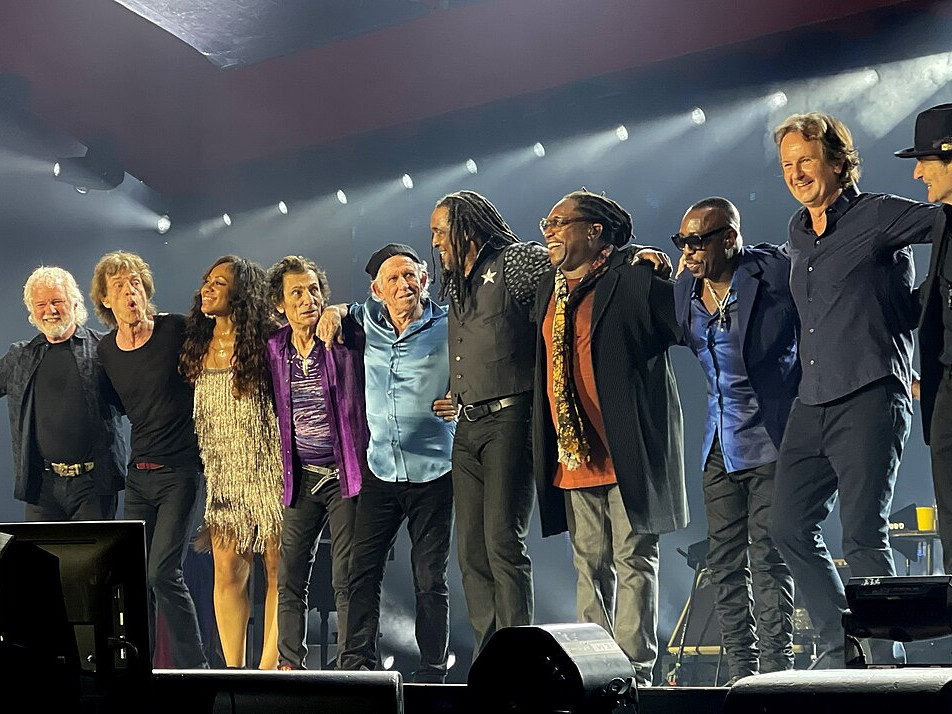 The Rolling Stones and their touring musicians taking a bow after a St. Louis concert