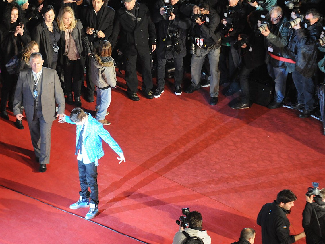 Justin Bieber greeting a crowd of fans at a public event