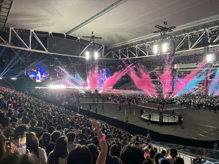 Coldplay performing onstage at Kai Tak Stadium in Hong Kong