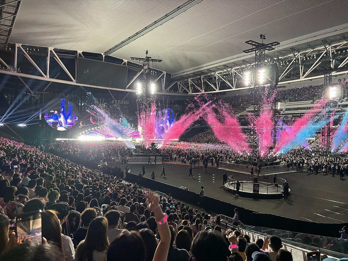 Coldplay performing onstage at Kai Tak Stadium in Hong Kong