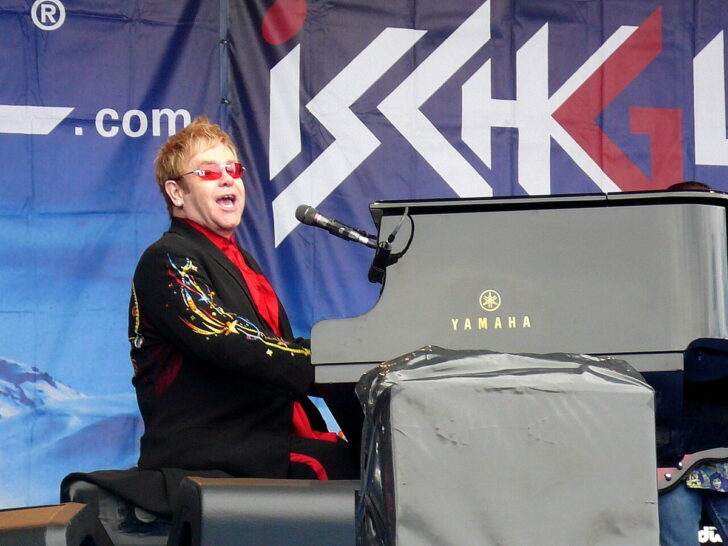 Elton John singing and playing piano during a concert in Ischgl