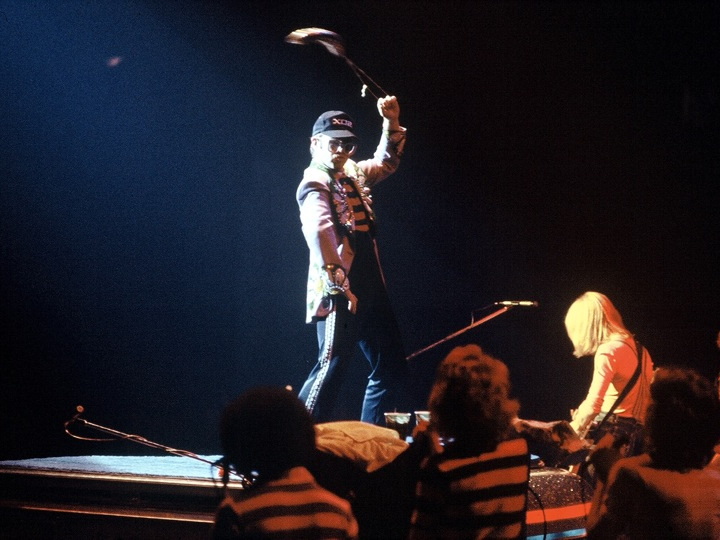 Elton John performing onstage in 1975