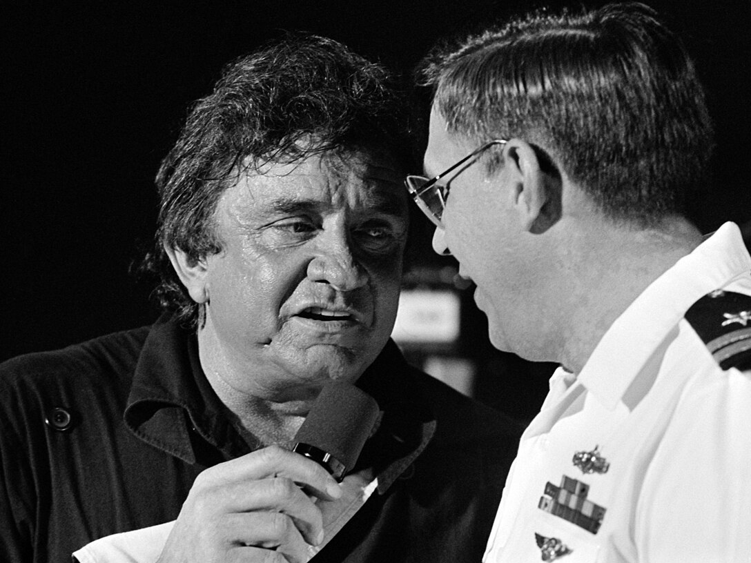 Johnny Cash singing a duet with a United States Navy lieutenant