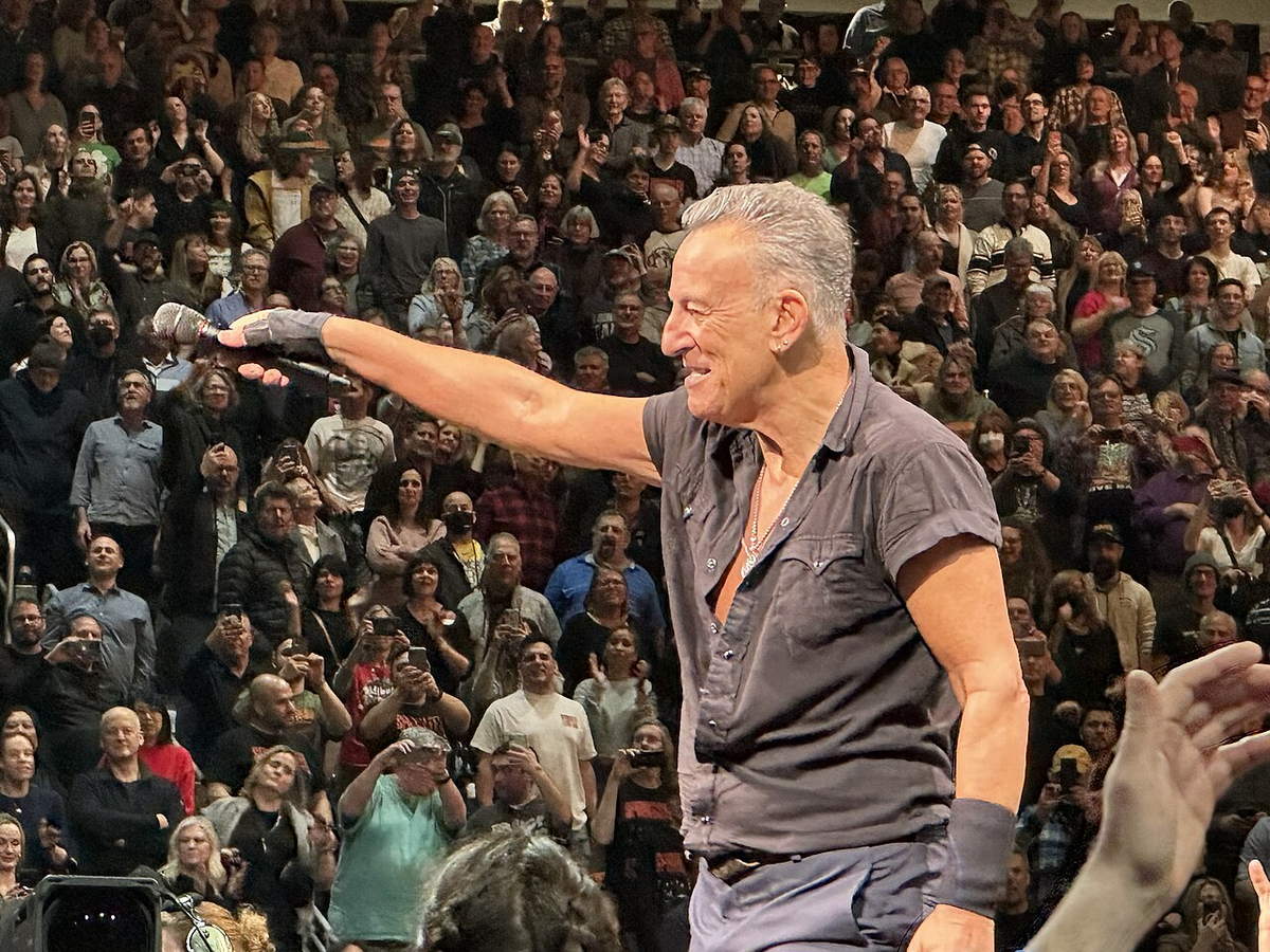 Bruce Springsteen performing with a guitar onstage in Seattle in 2023