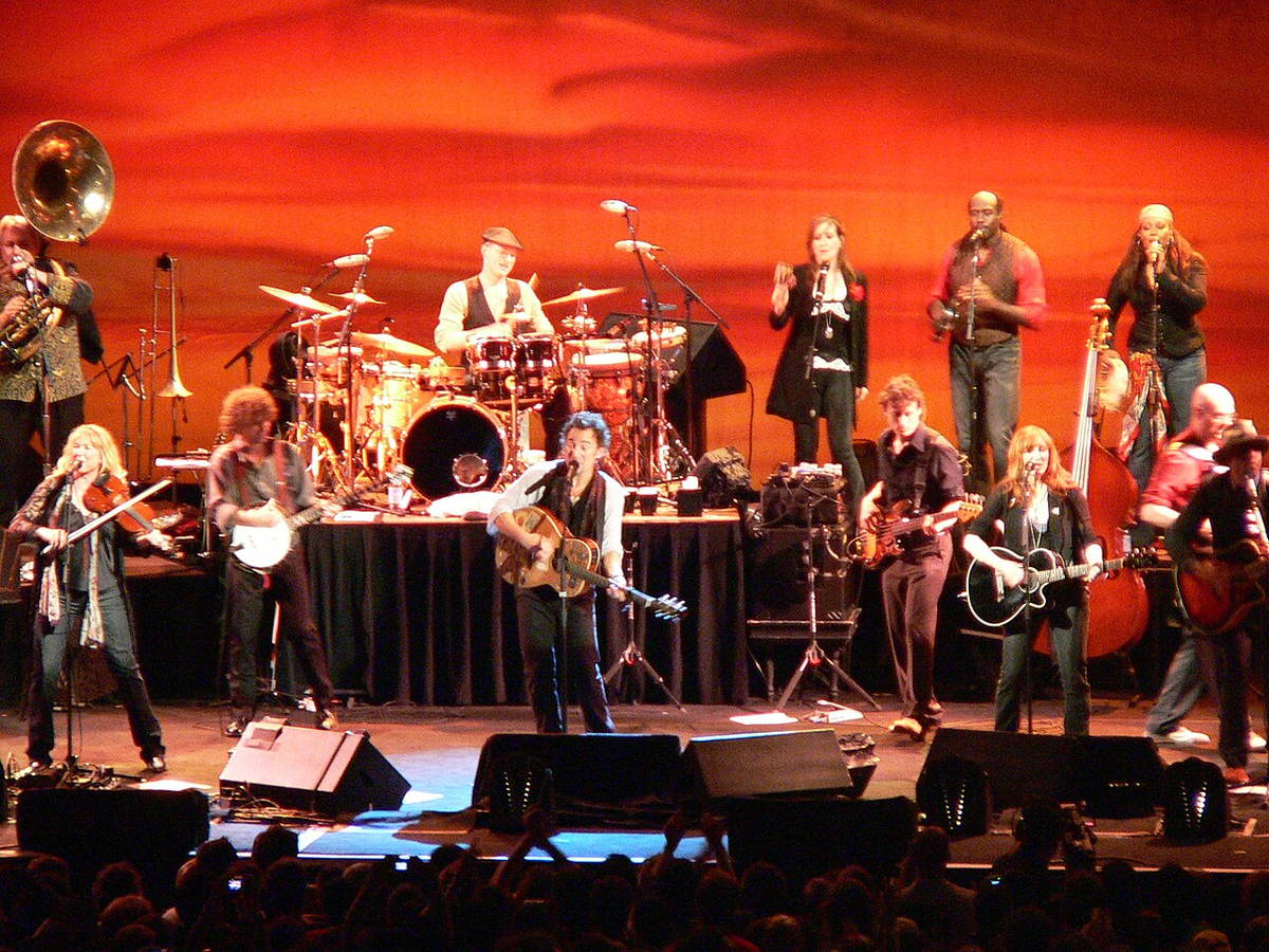 Bruce Springsteen singing and playing guitar during a concert in Milan in 2006