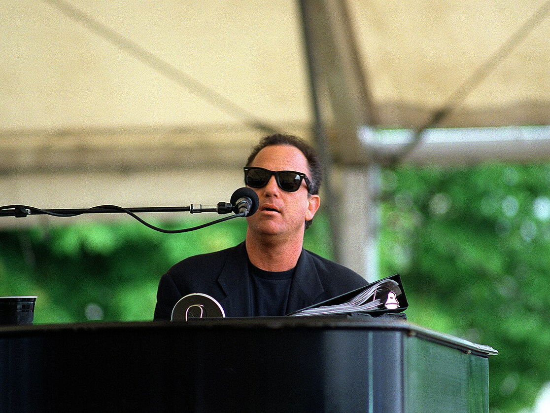 Billy Joel performing live at a piano in 1994