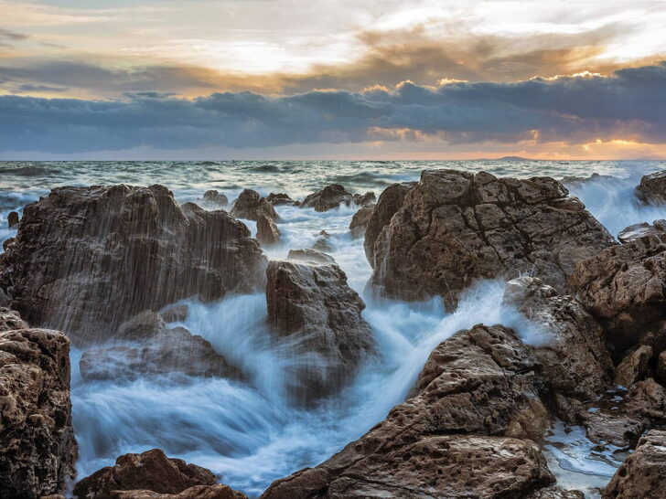 Ocean waves breaking against rocks at sunset in La Corniche, France