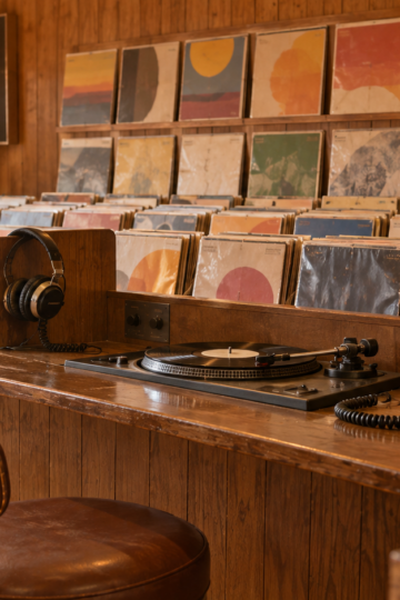 Early-1970s record store with turntable, headphones, and rows of album sleeves