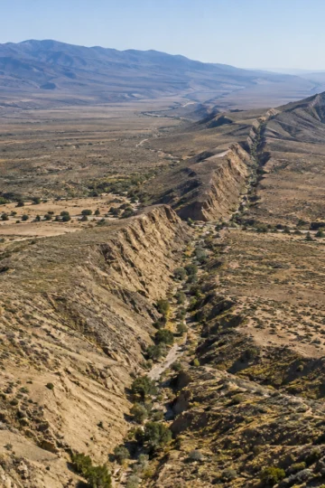 The San Andreas Fault forms a long valley through dry California hills