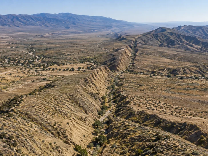 The San Andreas Fault forms a long valley through dry California hills