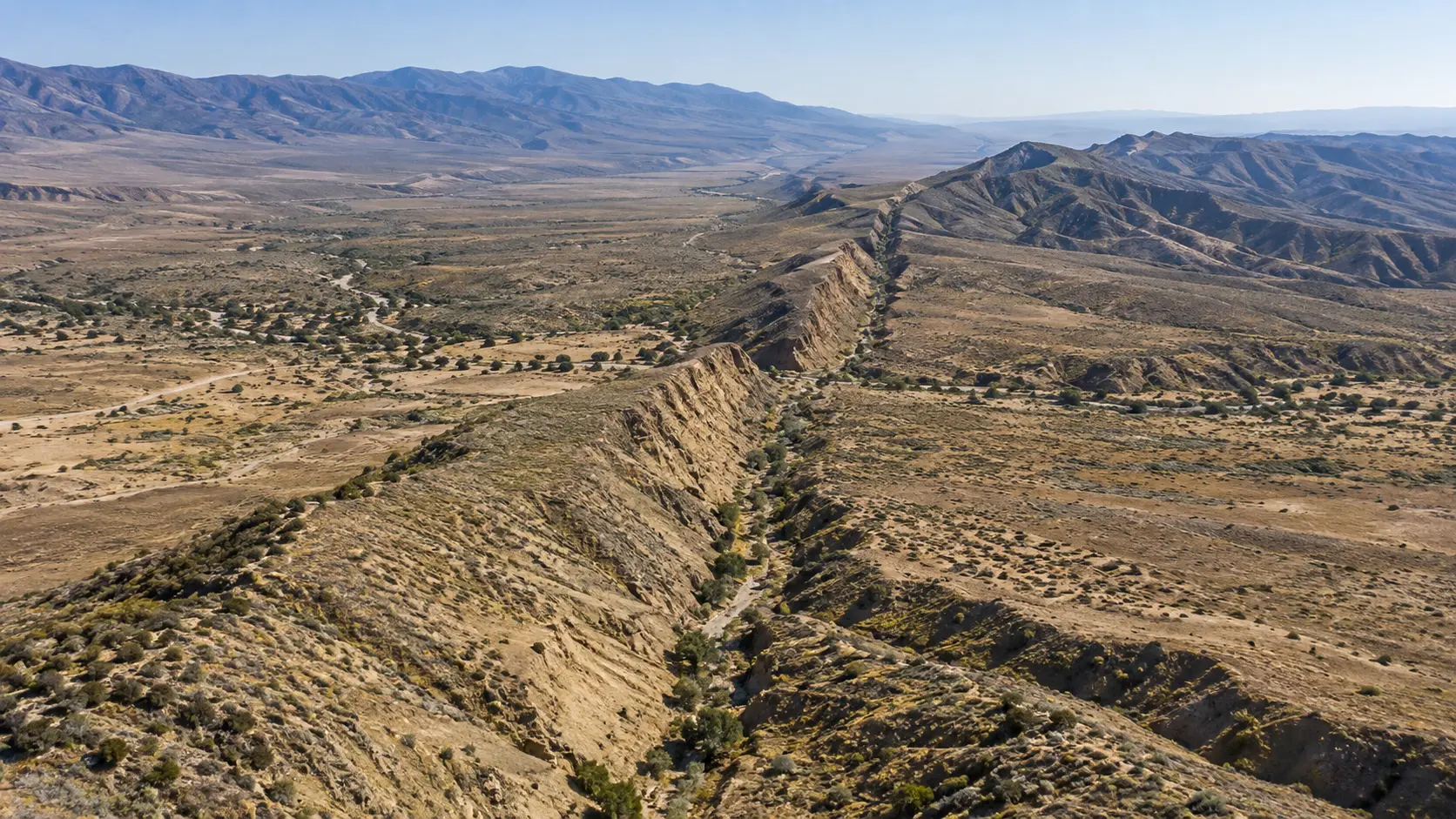 The San Andreas Fault forms a long valley through dry California hills