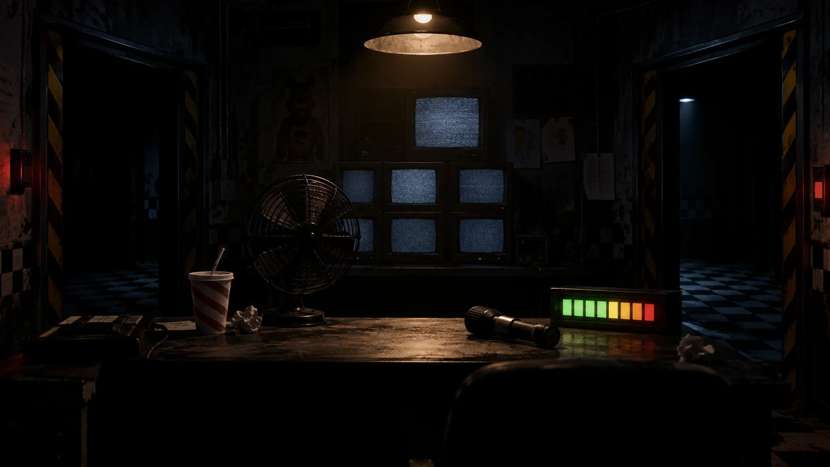 Dim security desk with static monitors fan flashlight and dark doorways