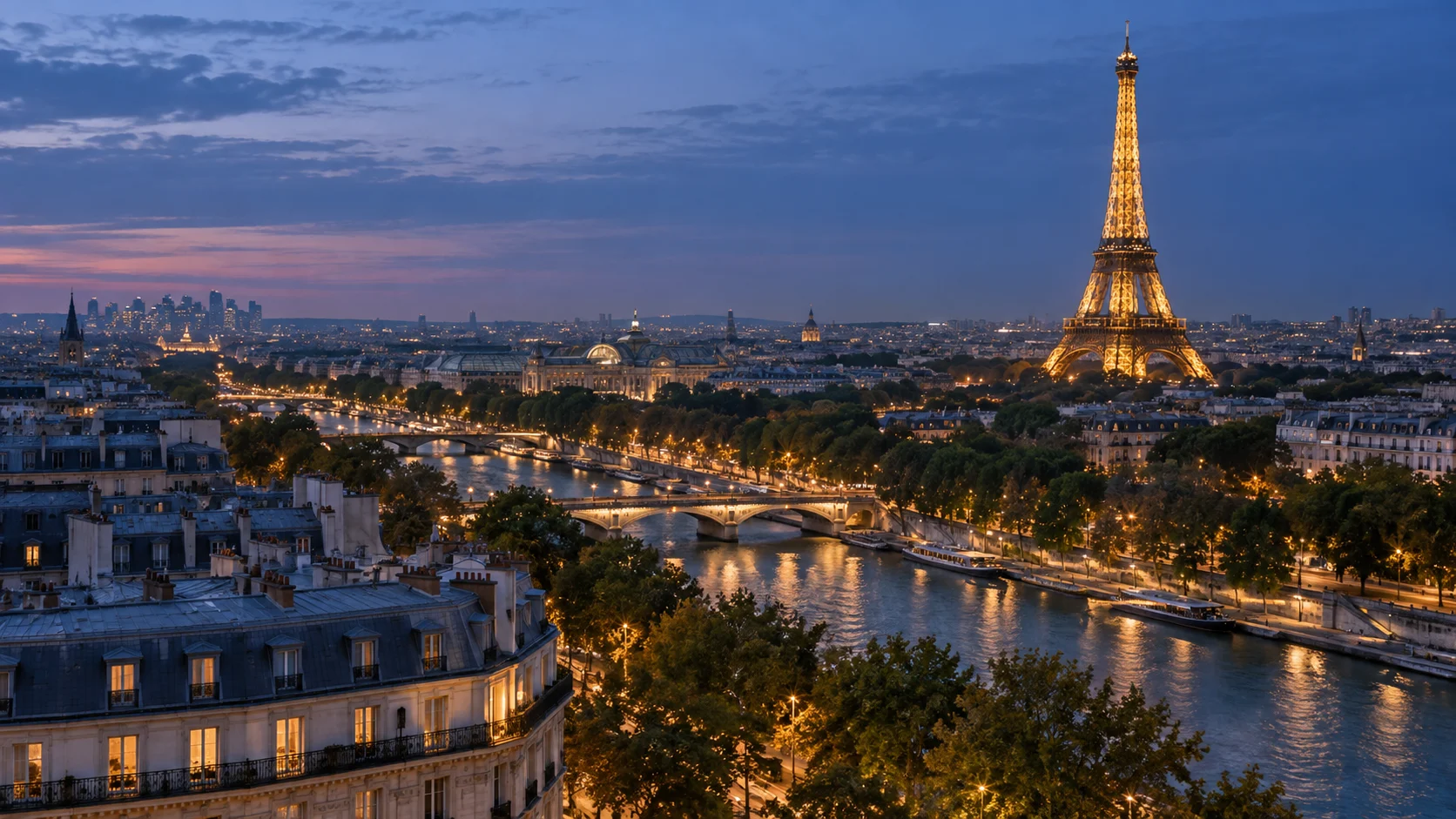 Eiffel Tower glowing above Paris and the Seine at blue hour