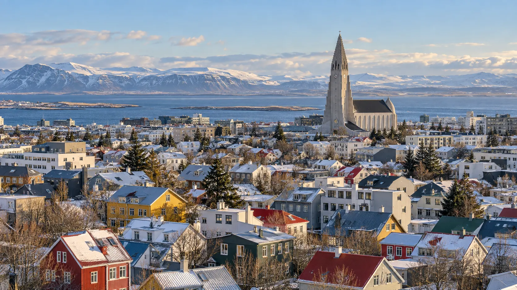 Colorful snowy Reykjavík rooftops leading toward Hallgrímskirkja and the bay
