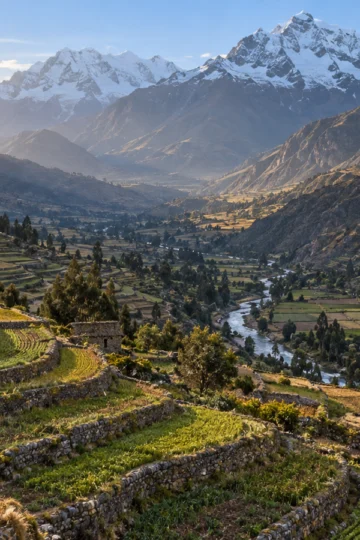 Agricultural terraces descending through a high Andean mountain valley
