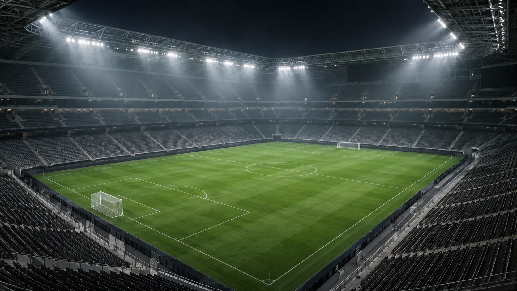 Floodlights illuminate the green pitch of an empty unbranded soccer stadium.