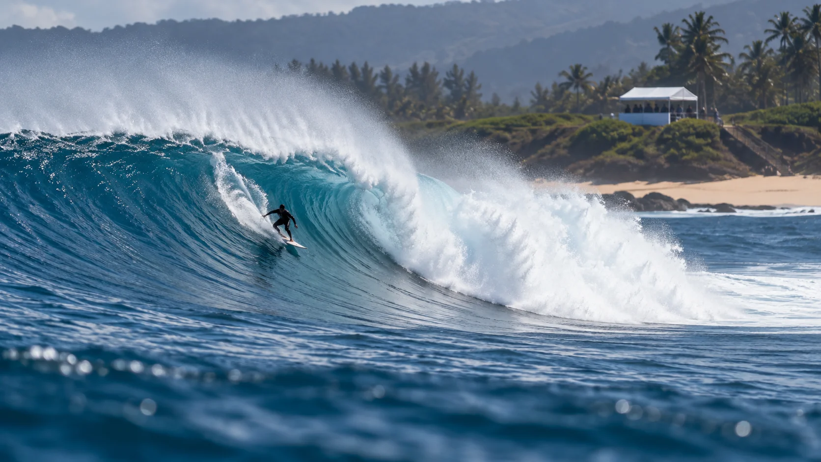 Distant anonymous surfer carving across a powerful blue wave