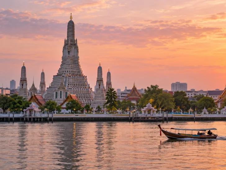 Wat Arun beside Bangkok's Chao Phraya River at sunrise