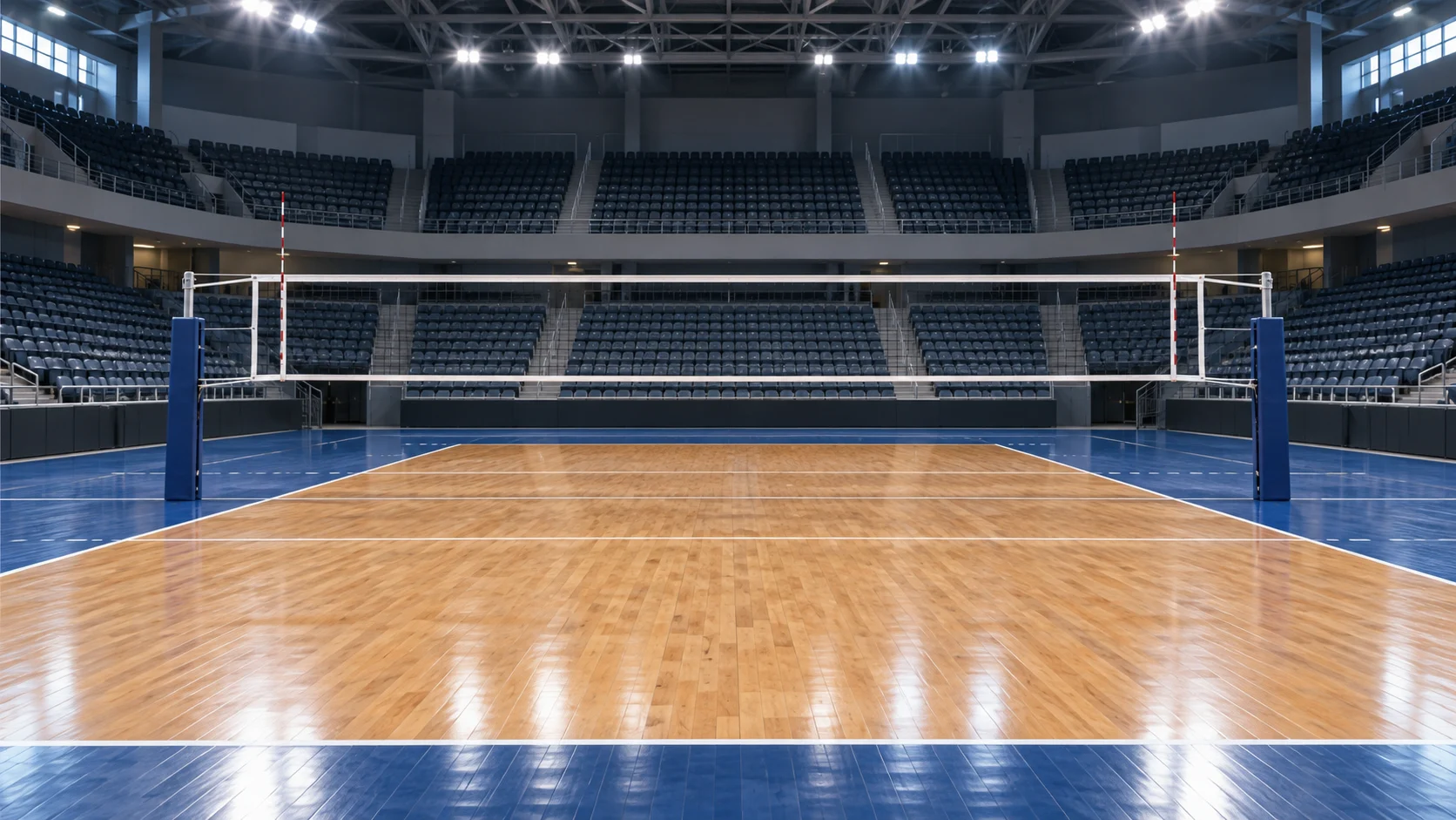 Empty indoor volleyball arena with a regulation net and polished court